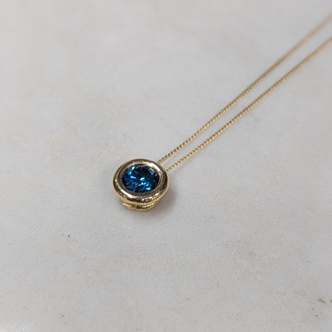 ANNE MORGAN - RBC Blue treated diamond (.49ct) on threaded rub over setting in 18ct