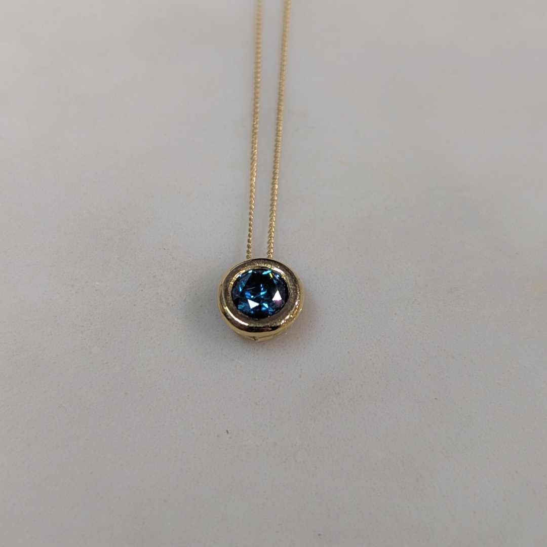 ANNE MORGAN - RBC Blue treated diamond (.49ct) on threaded rub over setting in 18ct