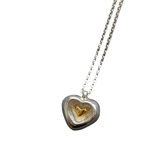 CLAIRE QUICK - Hand carved silver heart with a smaller heart carved inside